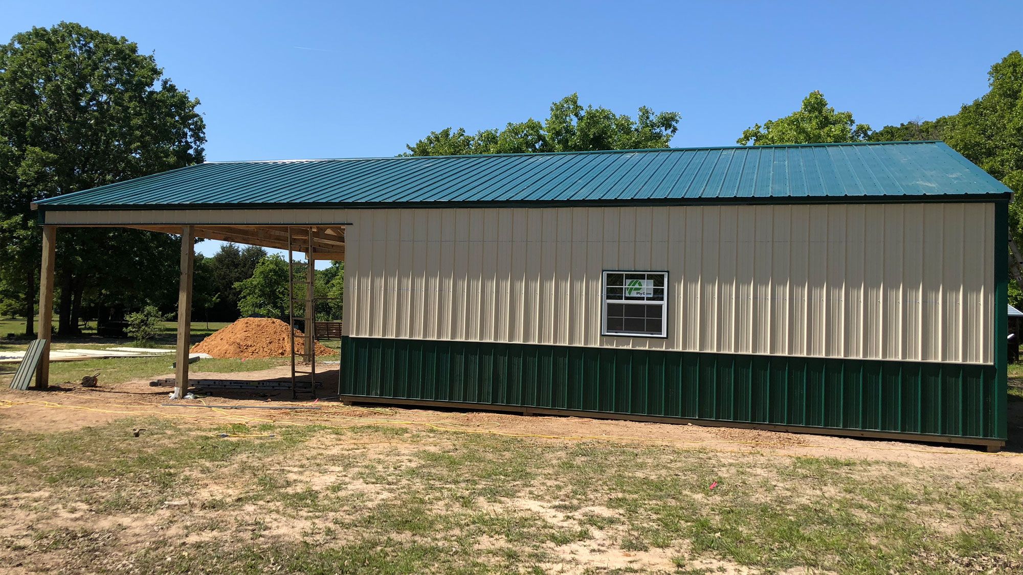 Exterior shot showing a barn standing strong in a rural Texas landscape